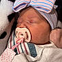 baby, blanket, blue, bow, closeup, cozy, cute, face, hat, infant, newborn, pacifier, peaceful, pink, skin, sleeping, soft, striped, striped_clothing, white