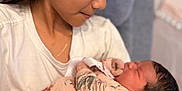 Kendra joined the competition — help win amazing prizes! arm, baby, blanket, caring, chair, child, closeup, clothing, face, family, floral, girl, head, holding, indoor, love, newborn, person, portrait, skin