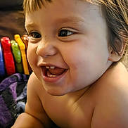 Jace joined the competition — help win amazing prizes! baby, smiling, laughing, child, blanket, indoor, toys, colorful, happy, face, head, arm, skin, person, couch, furniture, home, closeup, infant, cheerful