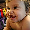 baby, smiling, laughing, child, blanket, indoor, toys, colorful, happy, face, head, arm, skin, person, couch, furniture, home, closeup, infant, cheerful