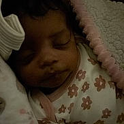 Kahlani is registered to the contest to win money with this photo: baby, blanket, child, closeup, comfort, cozy, cute, dark, face, floral_pattern, headband, indoors, infant, pajamas, peaceful, portrait, resting, sleeping, soft_texture, wrapped