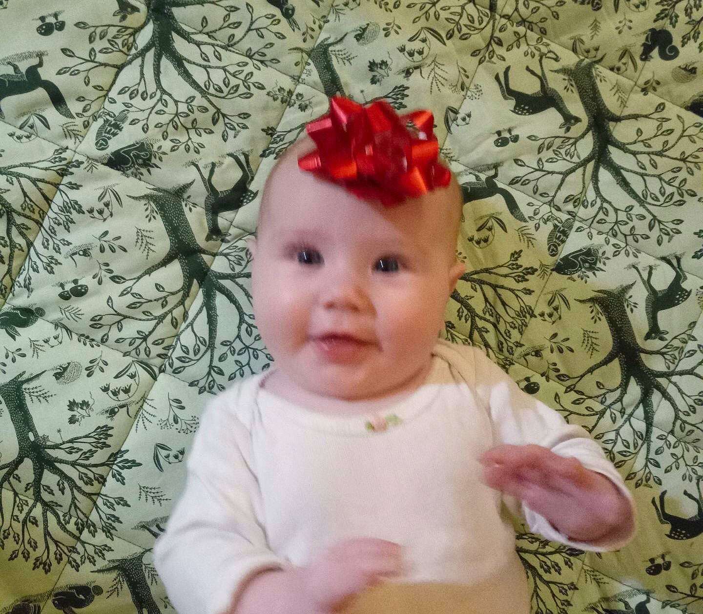 Lucie joined the competition — help win amazing prizes! baby, baby_toddler_clothing, cap, cheek, child, costume_hat, eye, happy, headgear, headpiece, headwear, lip, pattern, person, pink, plant, skin, sleeve, smile, t_shirt