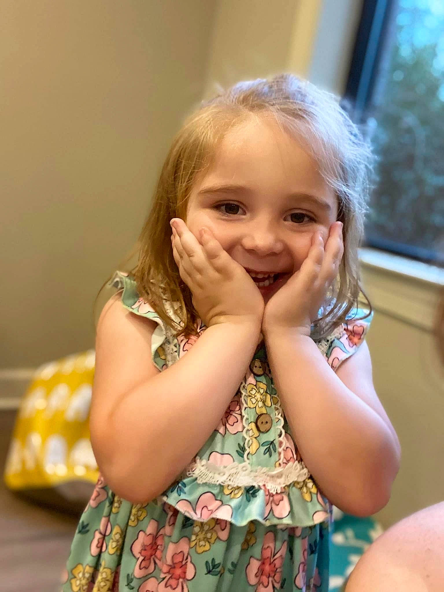 Annalynn is registered to the contest to win money with this photo: arm, baby_toddler_clothing, blond, cheek, child, day_dress, eye, eyelash, face, fun, gesture, happy, iris, joy, pattern, person, room, sleeve, smile, thumb