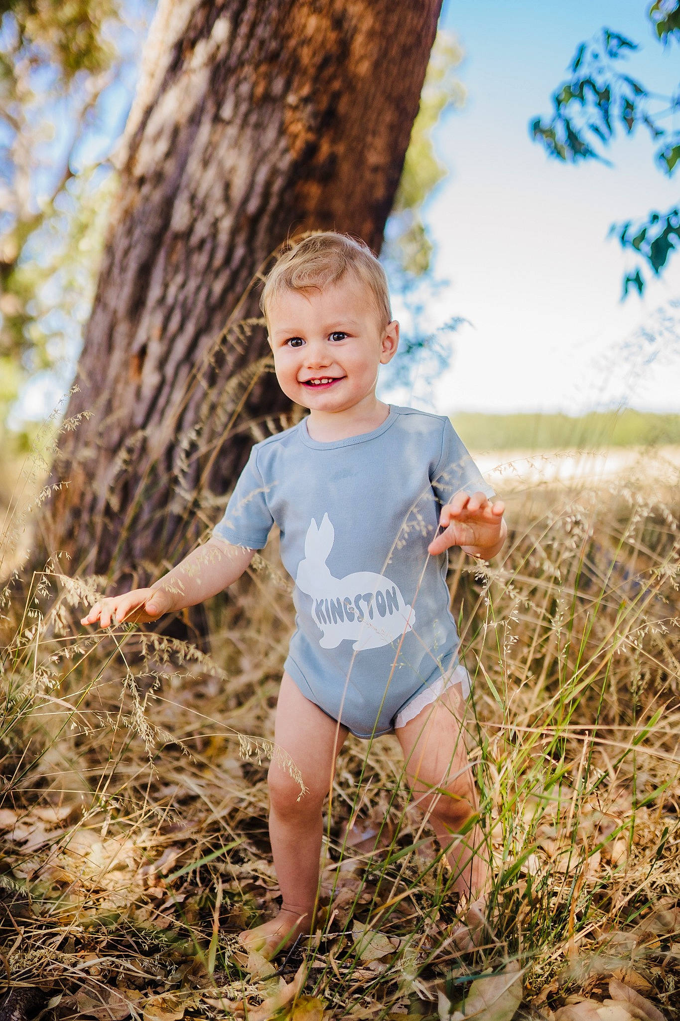 Kingston is registered to the contest to win money with this photo: arm, child, face, flash_photography, fun, grass, happy, head, joy, leisure, people_in_nature, person, plant, recreation, sky, smile, soil, t_shirt, toddler, tree