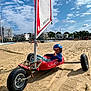 Eléonore participe au concours pour gagner de l'argent avec cette photo : adult, beach, boat, buggy, coast, female, helmet, kart, machine, nature, outdoors, person, sea, shoreline, tire, transportation, vehicle, water, wheel, woman