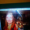 Snugglebears is registered to the contest to win money with this photo: woman, dog, person, portrait, smiling, red_hair, collar, blue_collar, television, screen, photograph, indoor, night, dark, grainy, scan_lines, date_stamp, retro, close_up, animal