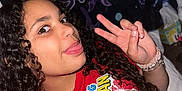 Jessa joined the competition — help win amazing prizes! child, curly_hair, peace_sign, tongue_out, red_tshirt, spiderman, indoor, blanket, butterfly, bracelets, smiling, person, portrait, casual, bedroom, youth, happy, fun, cute, colorful