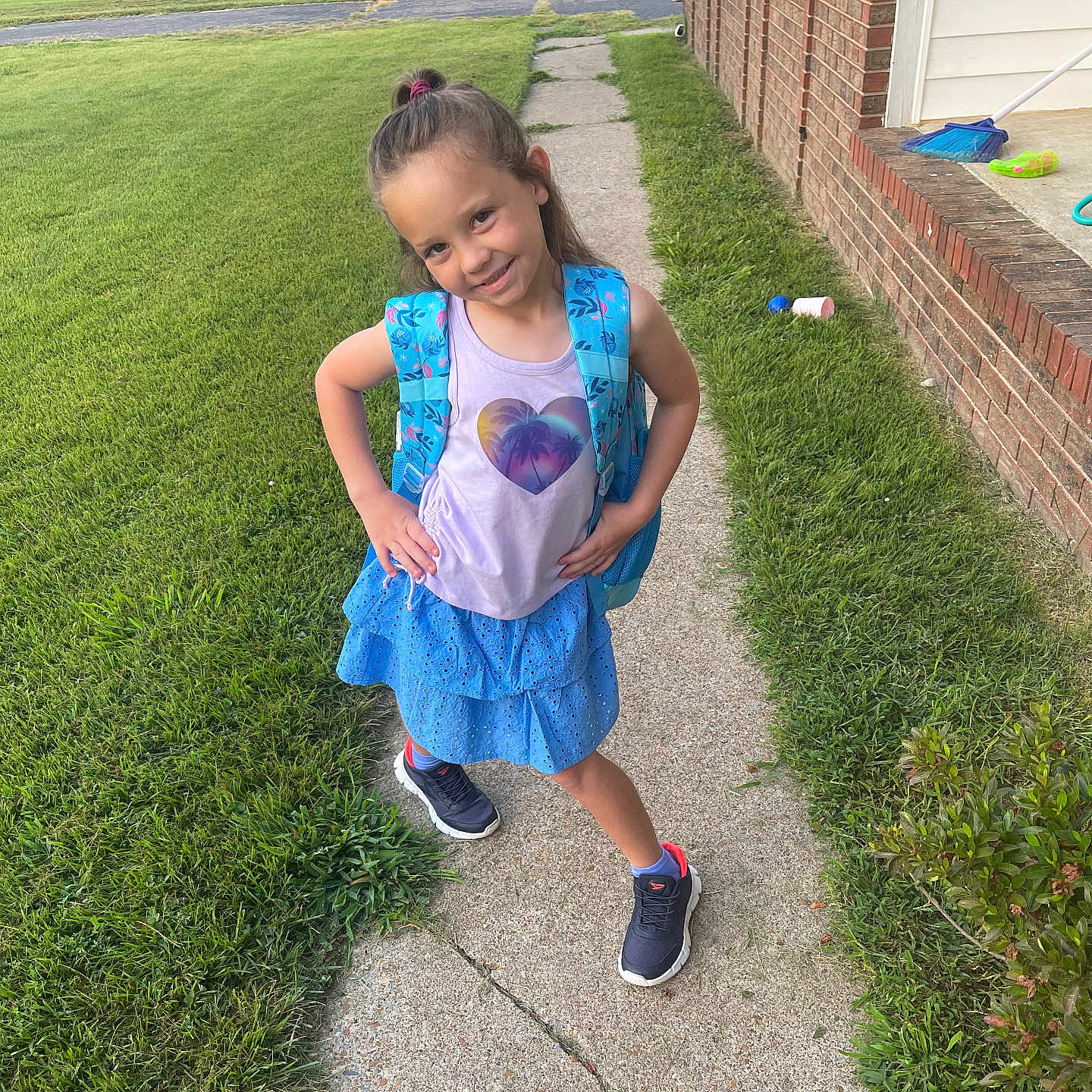 Jaelei joined the competition — help win amazing prizes! backpack, blue_skirt, brick_house, car, casual_clothing, child, daylight, girl, grass, hairstyle, lawn, outdoor, pose, shoes, sidewalk, smile, sneakers, suburban, tank_top, tree
