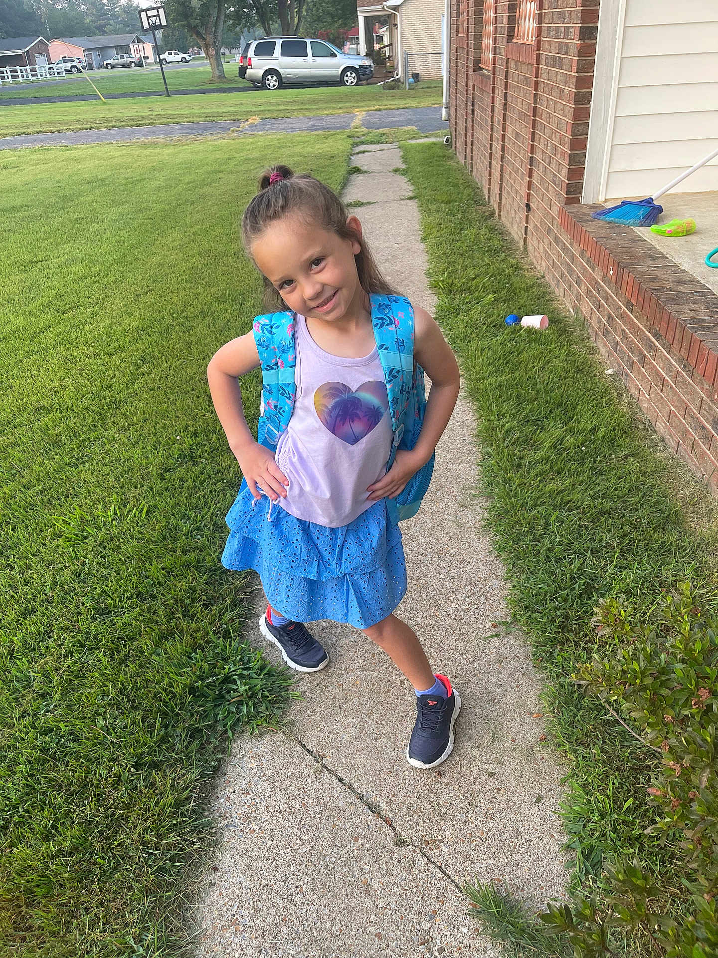 Jaelei joined the competition — help win amazing prizes! child, girl, backpack, sidewalk, grass, lawn, brick_house, sneakers, blue_skirt, tank_top, smile, outdoor, suburban, car, tree, shoes, casual_clothing, hairstyle, pose, daylight