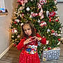Dalaya joined the competition — help win amazing prizes! child, girl, christmas_tree, holiday, ornaments, red_dress, festive, heart_hand_pose, puckered_lips, toy, furby, floor, boots, indoor, decorations, lights, gift_box, smile, holiday_spirit, celebration
