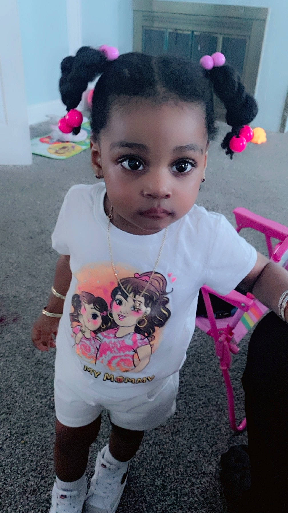 Truvena is registered to the contest to win money with this photo: baby_toddler_clothing, black, black_hair, cheek, eye, eyelash, face, hair, hairstyle, happy, head, headgear, lip, magenta, person, pink, skin, sleeve, t_shirt, toddler