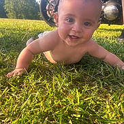 Noah joined the competition — help win amazing prizes! baby, child, grass, outdoor, sunlight, motorcycle, wheel, engine, smiling, crawling, happy, nature, greenery, skin, head, eyes, cheeks, person, daylight, background
