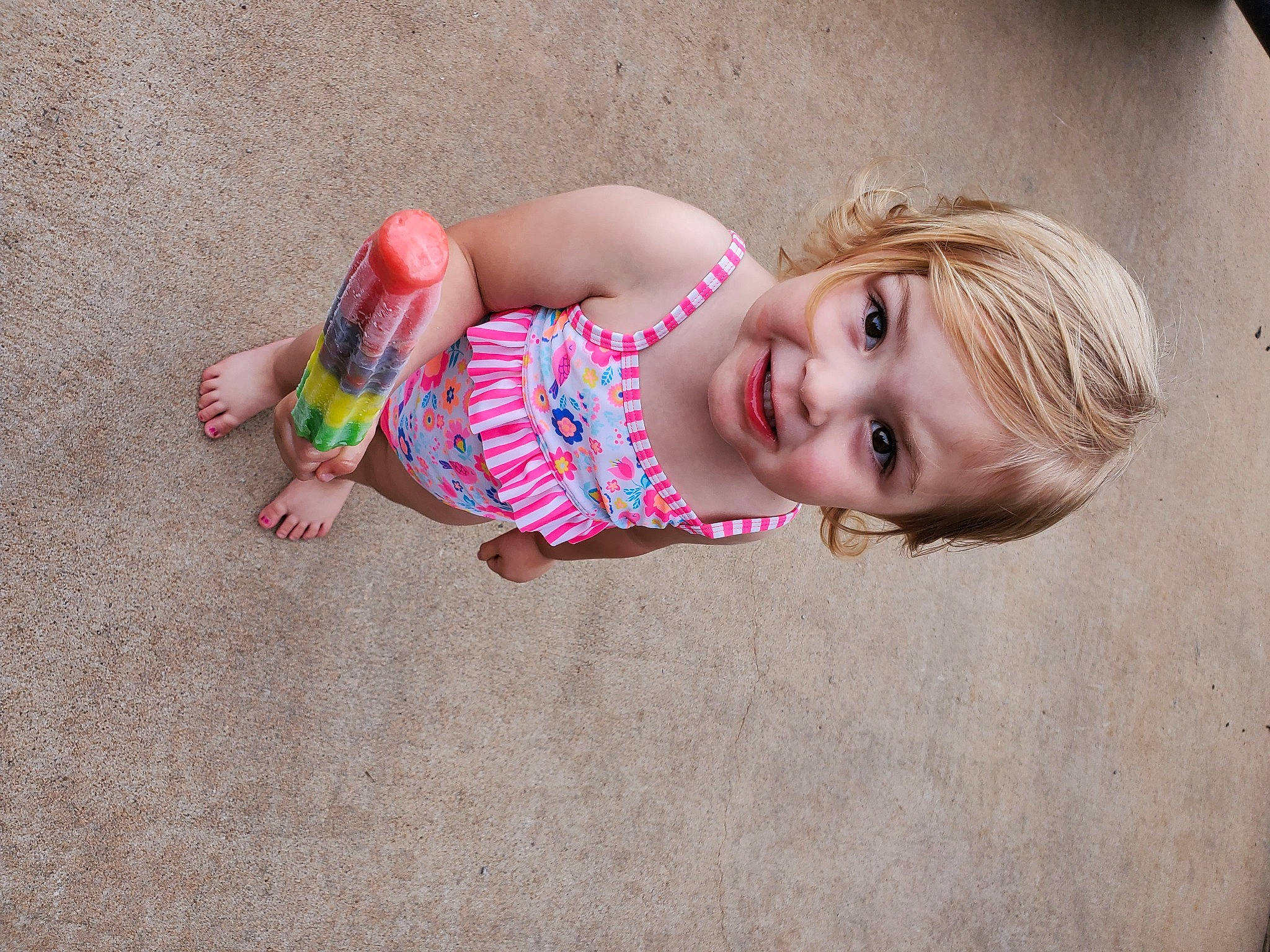 Aria is registered to the contest to win money with this photo: baby, beauty, child, floor, flooring, fun, joy, person, photography, pink, play, sand, skin, smile, toddler, vacation
