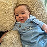 baby, child, smiling, blue_overalls, elephant_print, cushion, fluffy, comfort, indoor, cute, portrait, happy, infant, clothing, person, head, face, light, relaxed, cozy