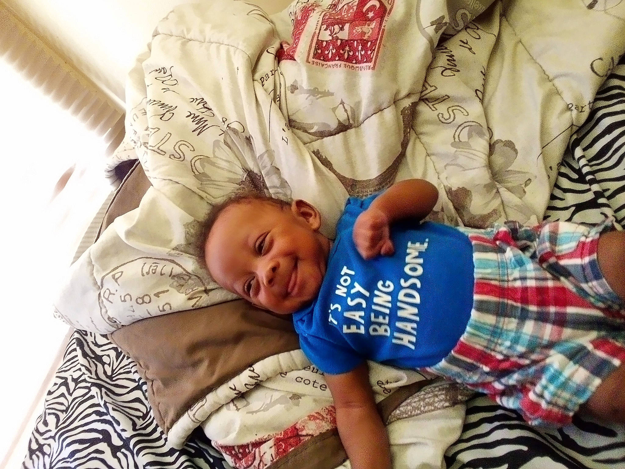 Nylon is registered to the contest to win money with this photo: abdomen, baby, baby_toddler_clothing, bedtime, child, comfort, couch, elbow, fun, happy, hat, joy, linens, mammal, pattern, person, plaid, sleeve, t_shirt, tartan