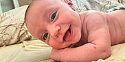 Victor participe au concours pour gagner de l'argent avec cette photo : baby, bed, bedding, cheeky, child, closeup, cute, expression, face, happy, head, indoor, infant, lying_down, person, relaxed, resting, skin, smiling, young