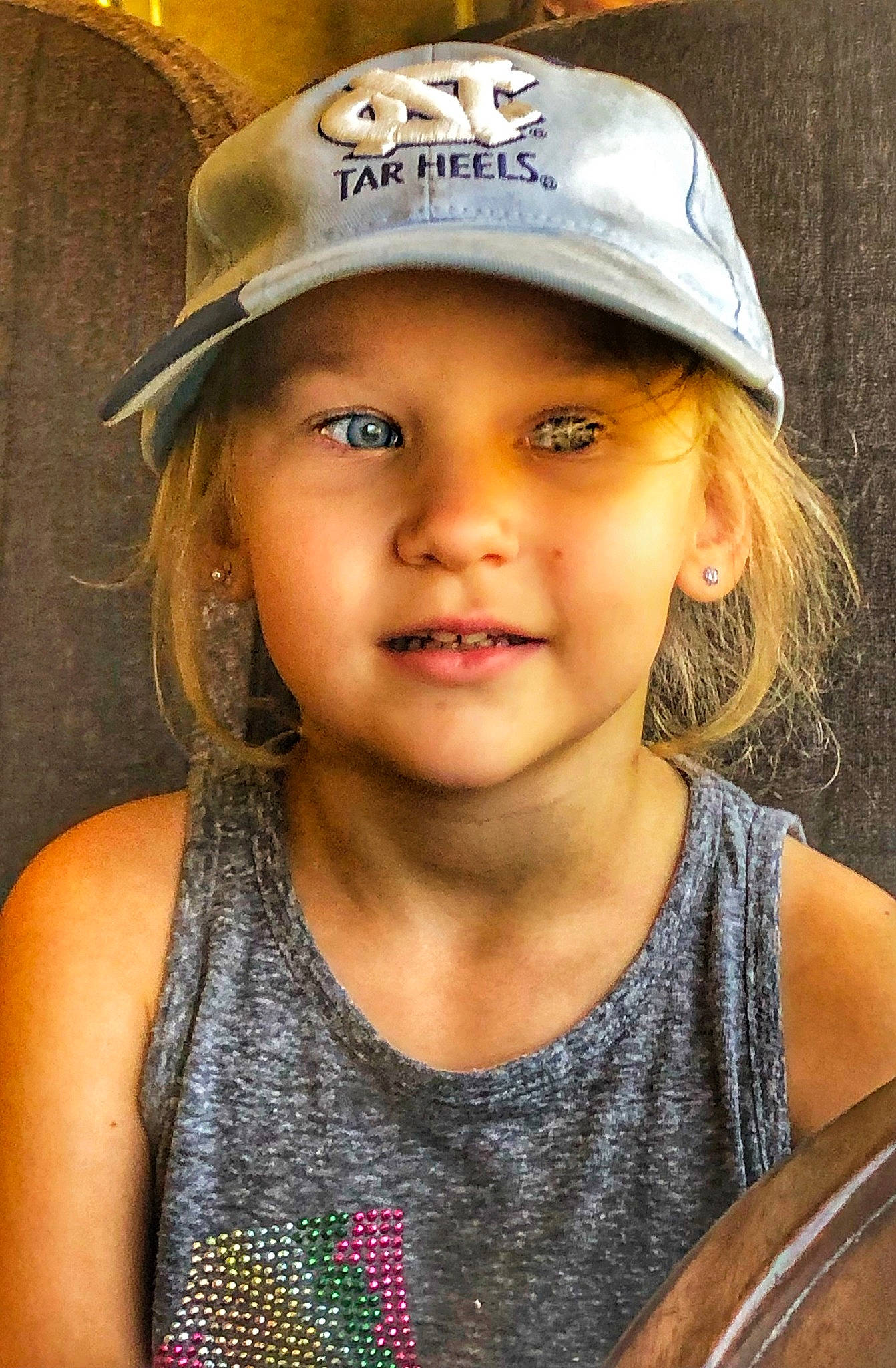 Amber is registered to the contest to win money with this photo: active_tank, baseball_cap, blond, cap, child_model, clothing, cool, cricket_cap, eye, feathered_hair, headgear, headwear, iris, lip, mouth, nose, person, portrait, portrait_photography, sleeveless_shirt