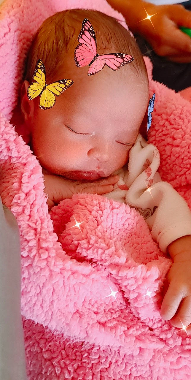 Rainn is registered to the contest to win money with this photo: arthropod, baby, butterfly, doll, dress, eye, eyelash, finger, hand, insect, lip, magenta, moths_and_butterflies, nail, person, petal, pink, pollinator, red, skin