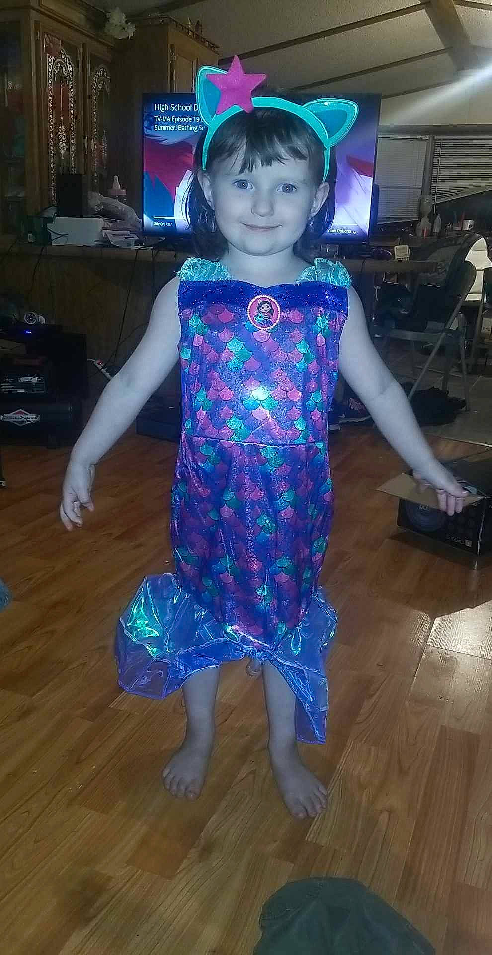 Angela is registered to the contest to win money with this photo: barefoot, child, costume, electric_blue, entertainment, event, fashion_design, flooring, fun, happy, hardwood, joy, laminate_flooring, magenta, pattern, person, purple, sleeve, smile, toddler