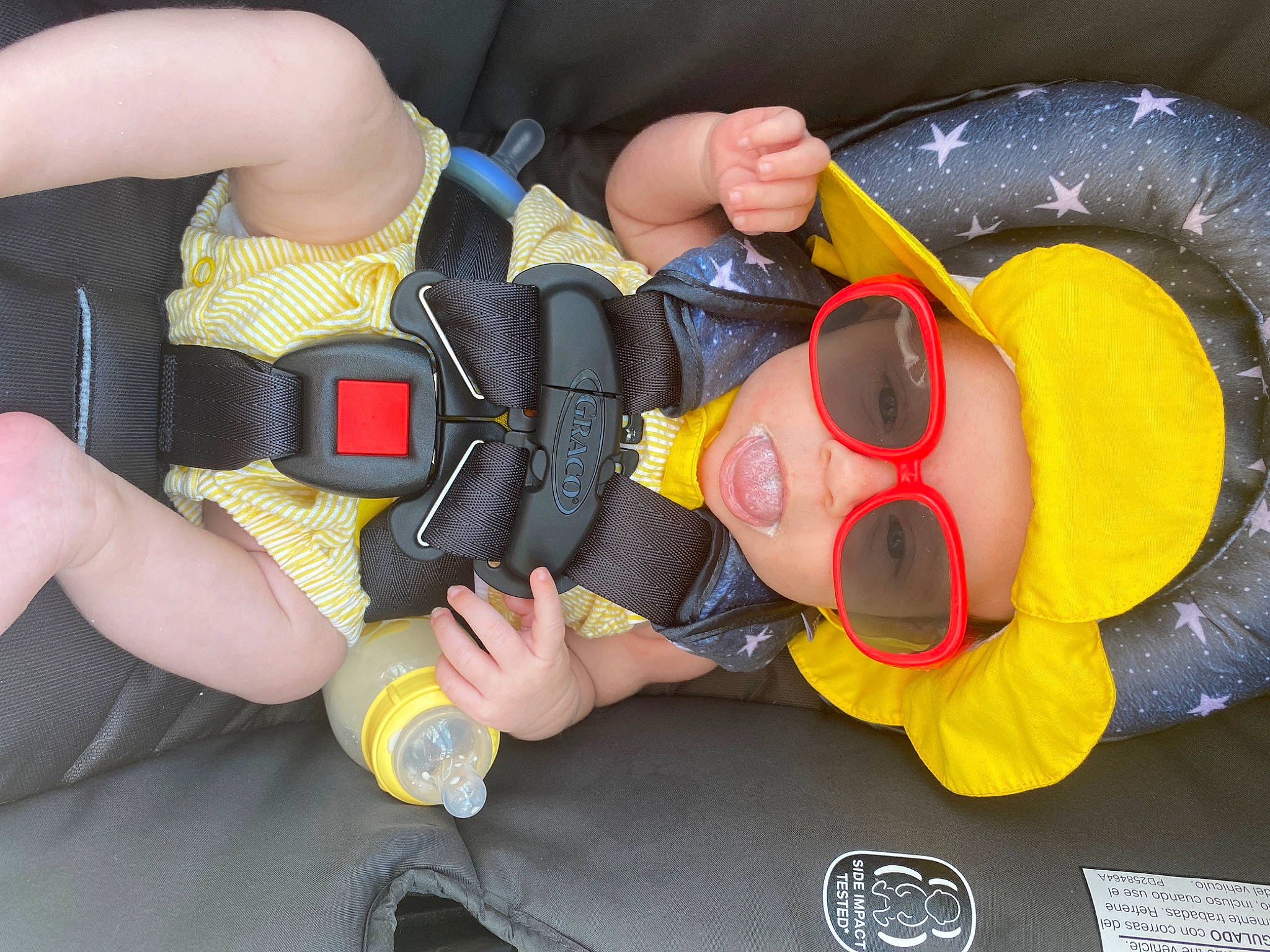 Maylynn is registered to the contest to win money with this photo: auto_part, baby_toddler_clothing, carmine, child, fictional_character, finger, fun, goggles, hat, headwear, knee, mouth, nail, person, personal_protective_equipment, plastic, service, sunglasses, thigh, thumb