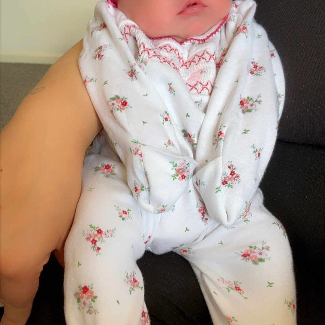 Maizie-Margo is registered to the contest to win money with this photo: accessories, baby, bonnet, clothing, costume, couch, dress, face, formalwear, furniture, glove, hat, head, newborn, pajamas, pants, person, photography, portrait, suit