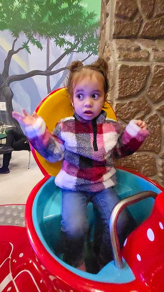 Tahlia is registered to the contest to win money with this photo: child, city, doll, electric_blue, fun, happy, leisure, magenta, person, pink, plastic, play, purple, recreation, sitting, surprise, toddler, toy, tree, vacation