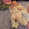 baby, infant, child, lying_down, sleepy, sucking_fingers, smiling, face, portrait, pink_clothing, pajamas, blanket, bed, stuffed_animal, lamb, minnie_mouse, nursery, indoor, cozy, soft_fabrics