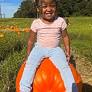 Skylar joined the competition — help win amazing prizes! child, girl, pumpkin, pumpkin_patch, smiling, outdoor, grass, blue_sky, clouds, trees, casual_clothing, pink_shoes, jeans, sunny, daylight, nature, playful, happy, beaded_hair, field