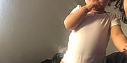 Zo-Rylah is registered to the contest to win money with this photo: toddler, child, onesie, bed, indoor, person, curly_hair, skin, face, standing, picking_nose, adult_partial, expression, casual, clothing, light, shadow, wall, hair, room