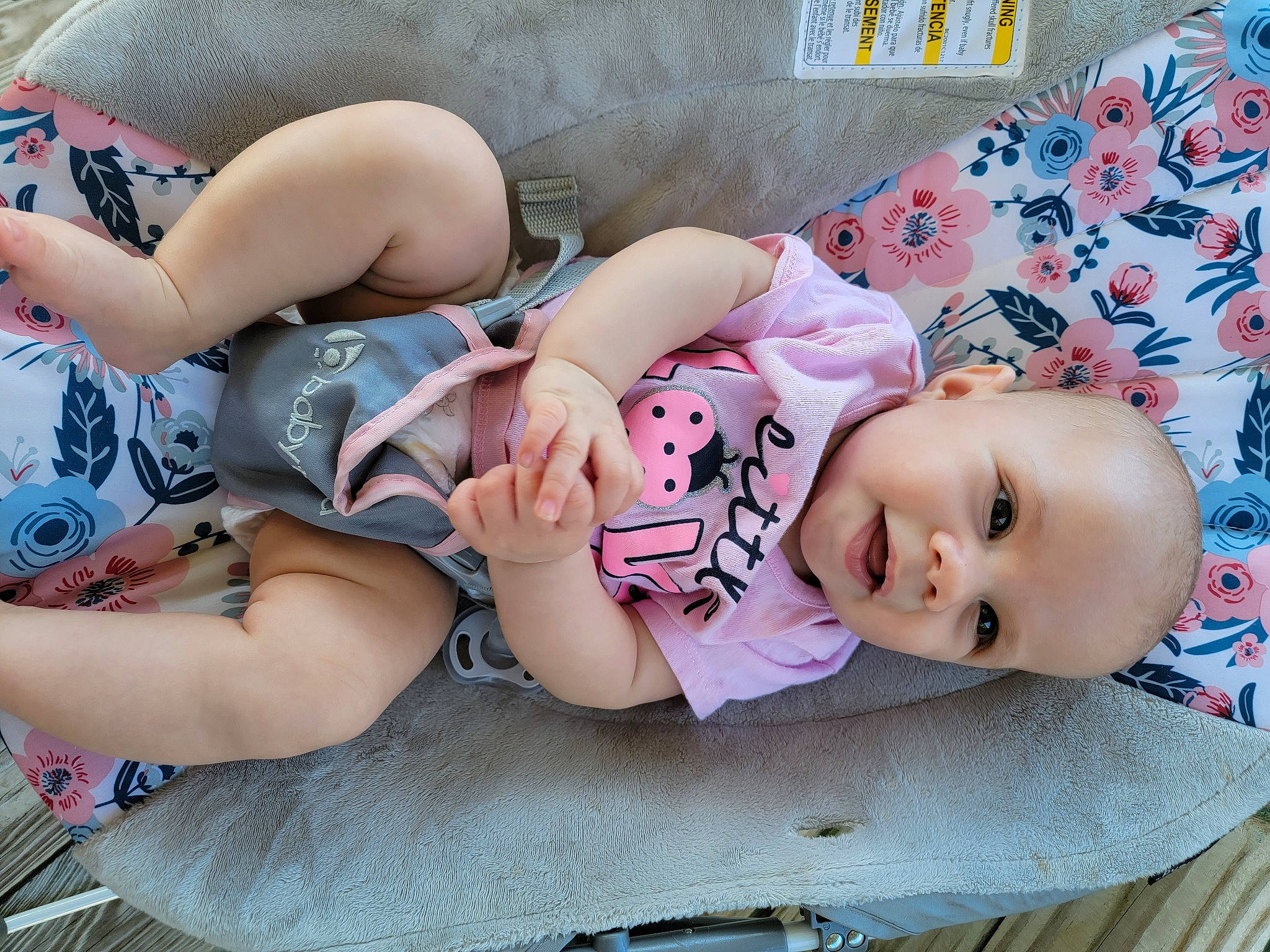 Lorelei is registered to the contest to win money with this photo: baby, baby_toddler_clothing, beauty, cheek, child, comfort, facial_expression, headgear, human_body, human_leg, lap, leg, pattern, person, pink, product, sitting, skin, textile, thigh