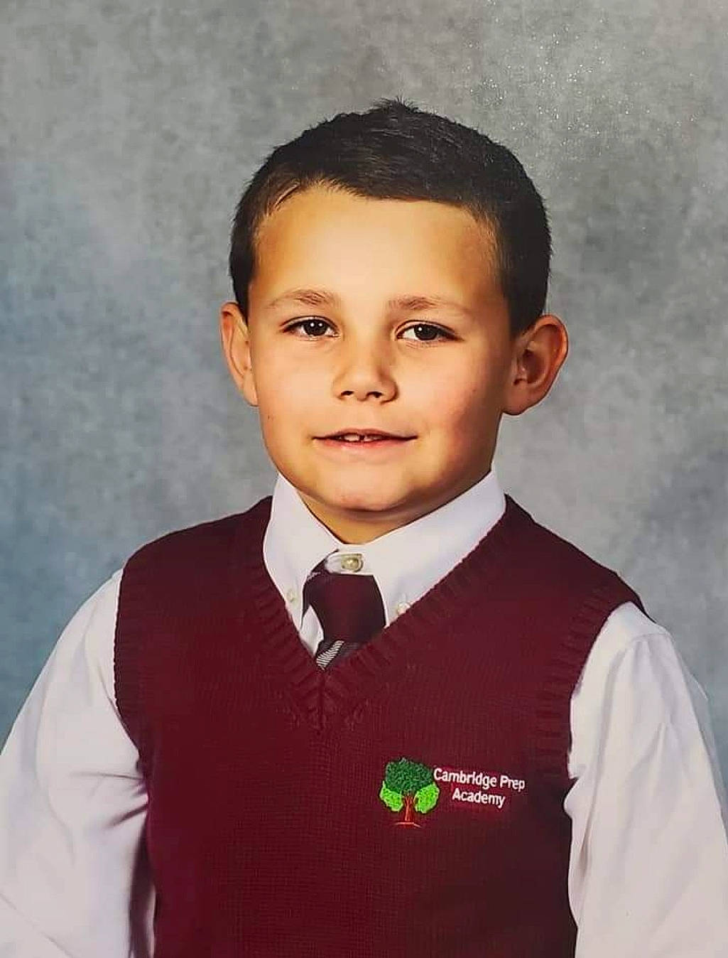 Jonah is registered to the contest to win money with this photo: blazer, child, chin, collar, dress_shirt, eyebrow, face, formal_wear, gesture, hair, happy, head, joy, person, pleased, school_uniform, sleeve, smile, tie, toddler