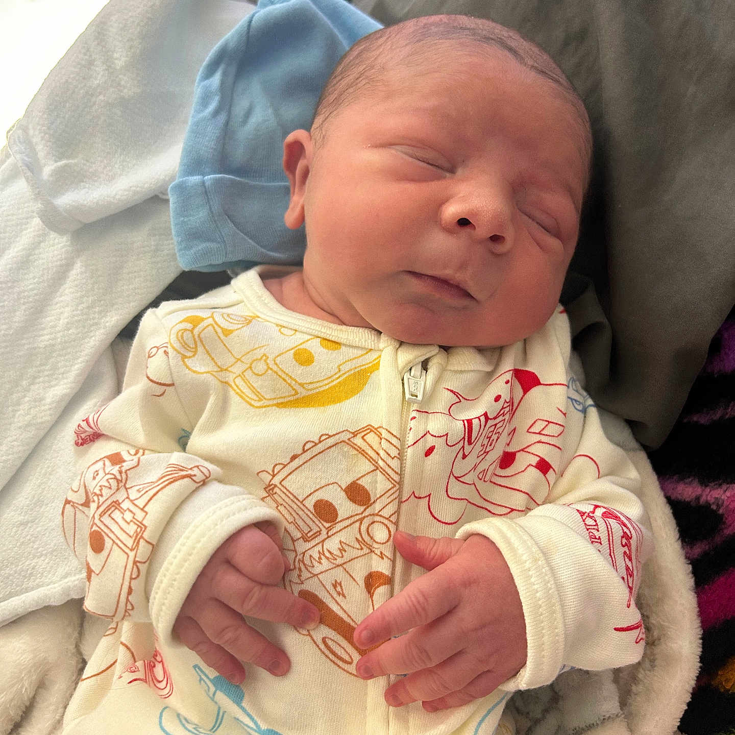Elijah is registered to the contest to win money with this photo: newborn, baby, sleeping, onesie, clothing, blanket, infant, cute, hand, face, cozy, soft, resting, indoors, child, peaceful, portrait, person, cute_baby, sleep