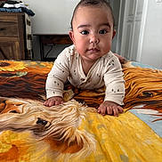 Waylon joined the competition — help win amazing prizes! baby, infant, crawling, bedspread, horse_art, indoor, child, portrait, clothing, furniture, wooden_table, blanket, home, person, cute, face, room, decor, table, expression