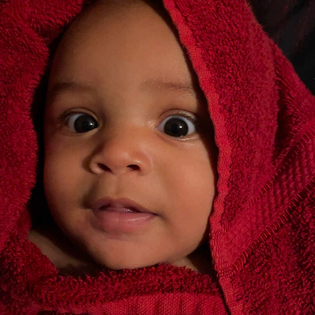 Corinthian is registered to the contest to win money with this photo: baby, bathtowel, blanket, bodypart, bonnet, clothing, face, finger, hat, head, hood, hoodie, knitwear, newborn, person, photography, portrait, sweater, sweatshirt, towel