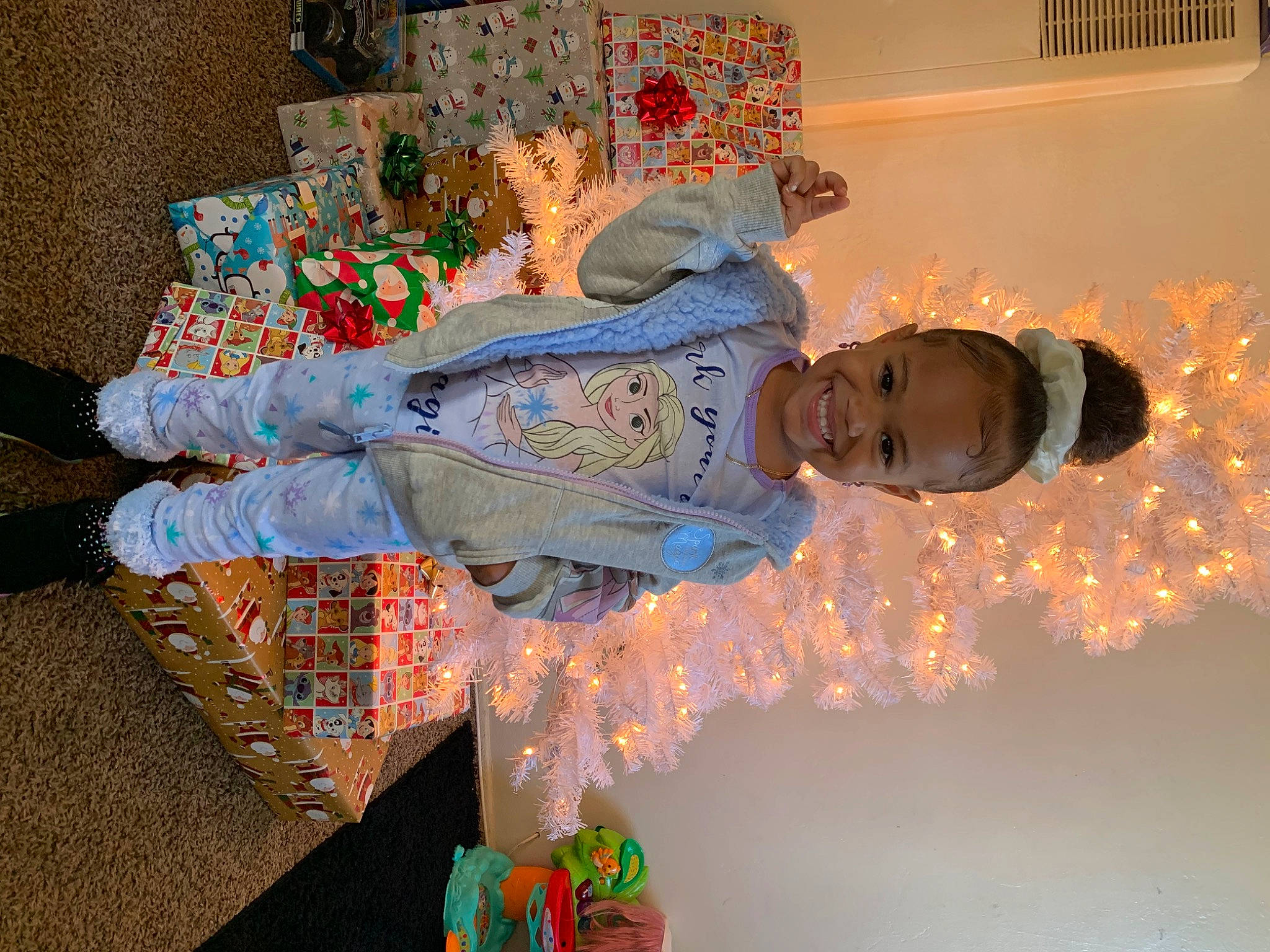 Jazelle is registered to the contest to win money with this photo: art, child, event, flooring, fun, happy, joy, linens, orange, pattern, person, room, smile, textile, tradition, visual_arts, window, world