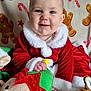 Emilia-Rose is registered to the contest to win money with this photo: baby, child, smiling, santa_outfit, red_clothing, plush_toy, elf_toy, holiday, christmas, gingerbread_pattern, blanket, festive, cute, indoor, portrait, happy, toddler, soft_toys, holiday_decor, festive_clothing