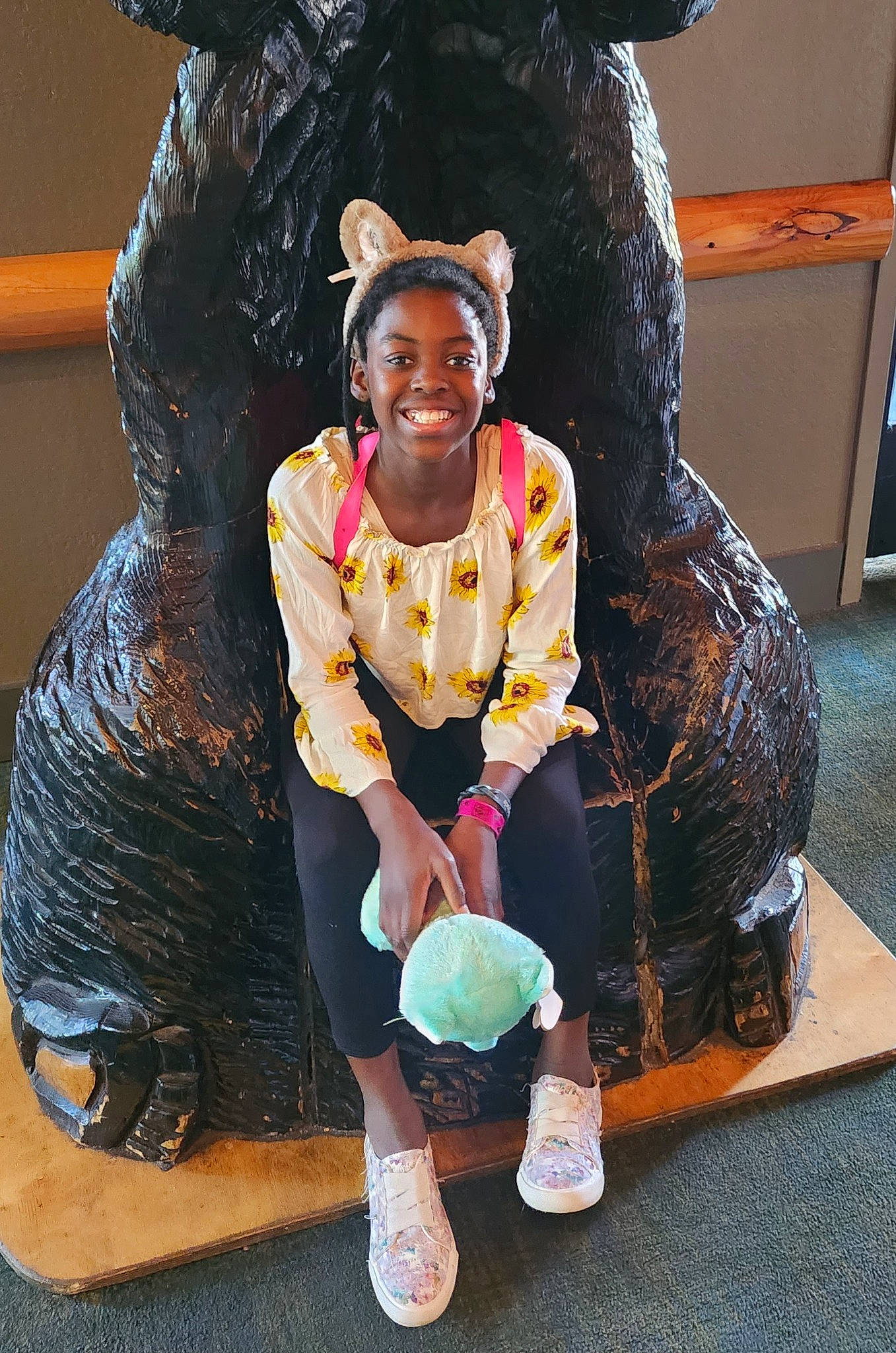 Corie is registered to the contest to win money with this photo: art, artist, boot, costume, event, flooring, fun, fur, happy, jewellery, joy, knee, leisure, performing_arts, person, sculpture, shoe, sitting, smile, sock