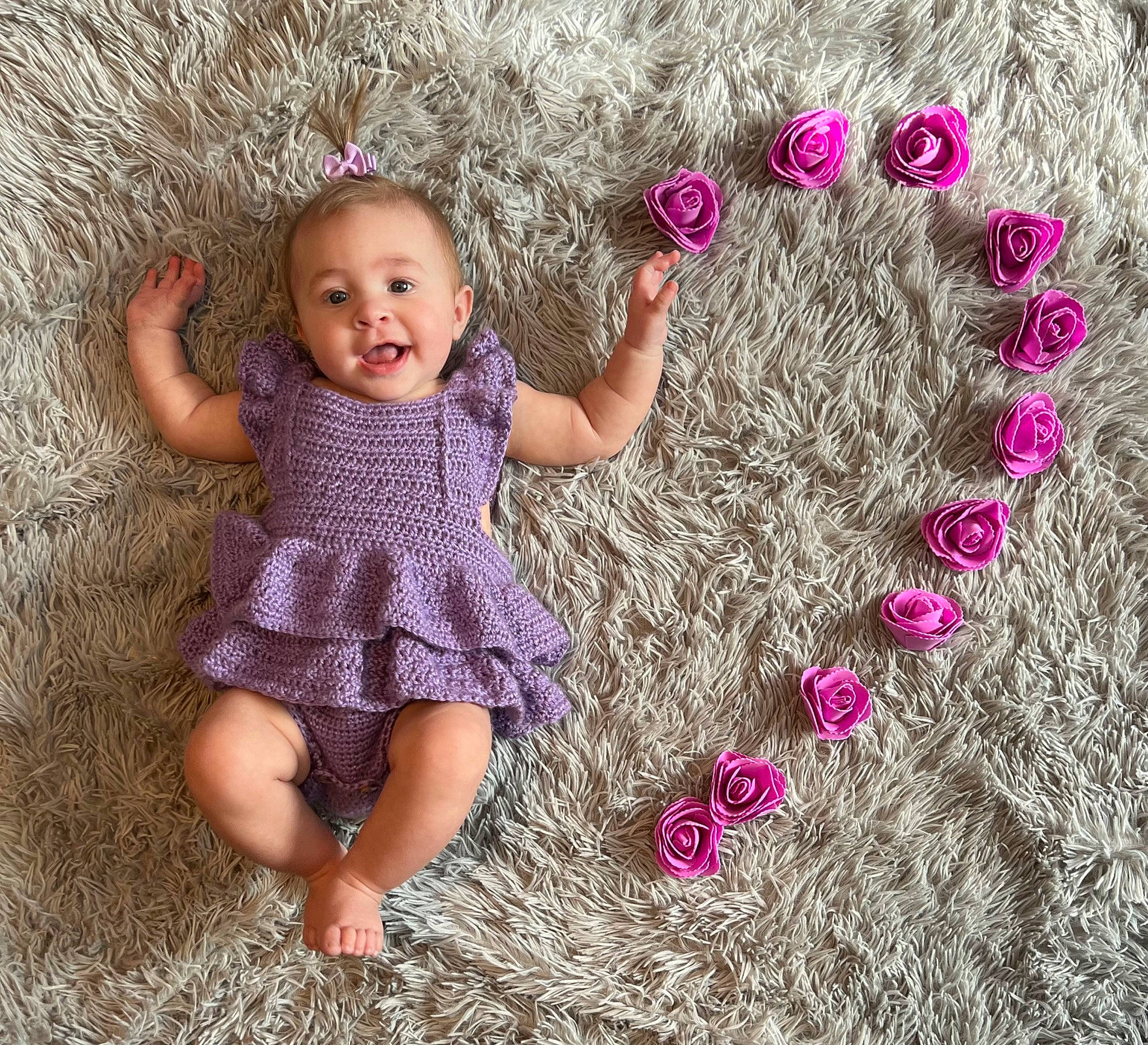 Everlee is registered to the contest to win money with this photo: arm, baby_toddler_clothing, dress, finger, hair, hand, happy, human, human_body, leg, people_in_nature, person, photograph, pink, purple, skin, sleeve, smile, textile, toddler