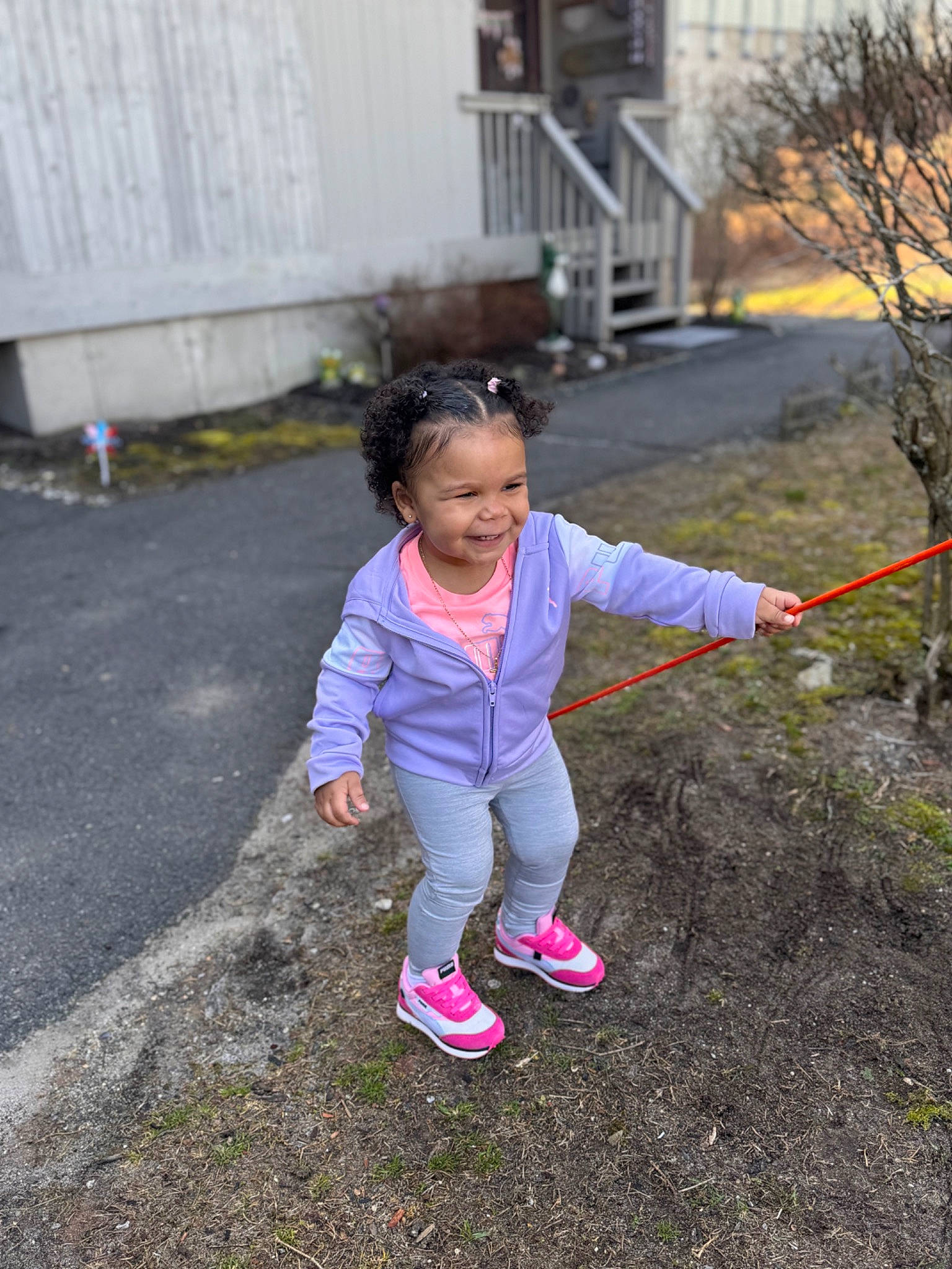 Zayla is registered to the contest to win money with this photo: asphalt, baby_toddler_clothing, child, face, fun, grass, happy, joy, leisure, magenta, people_in_nature, person, plant, play, recreation, road, road_surface, sneakers, soil, toddler