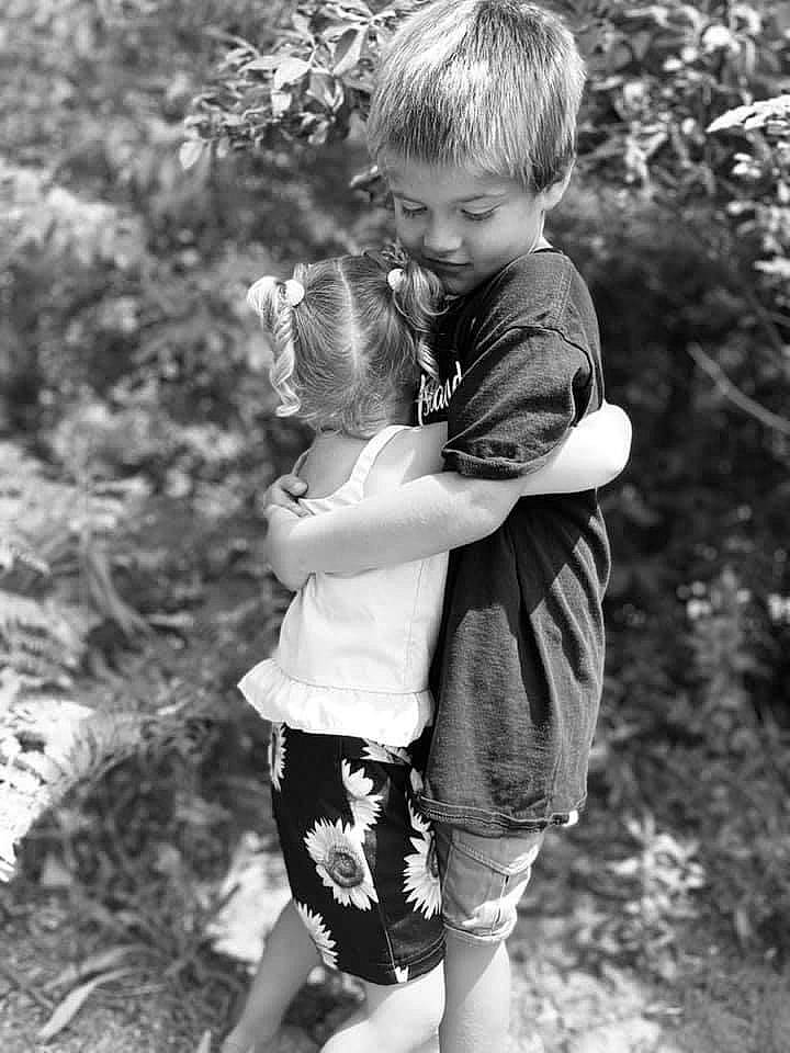 Micheal is registered to the contest to win money with this photo: black_and_white, child, eye, fun, gesture, happy, monochrome, monochrome_photography, people_in_nature, person, photograph, photography, plant, play, sibling, smile, snapshot, standing, stock_photography, toddler
