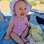 Leyna participe au concours pour gagner de l'argent avec cette photo : baby, child, smiling, hat, romper, pacifier, blanket, towel, outdoor, sunny, happy, sitting, cute, infant, skin, clothing, daylight, nature, joy, playful