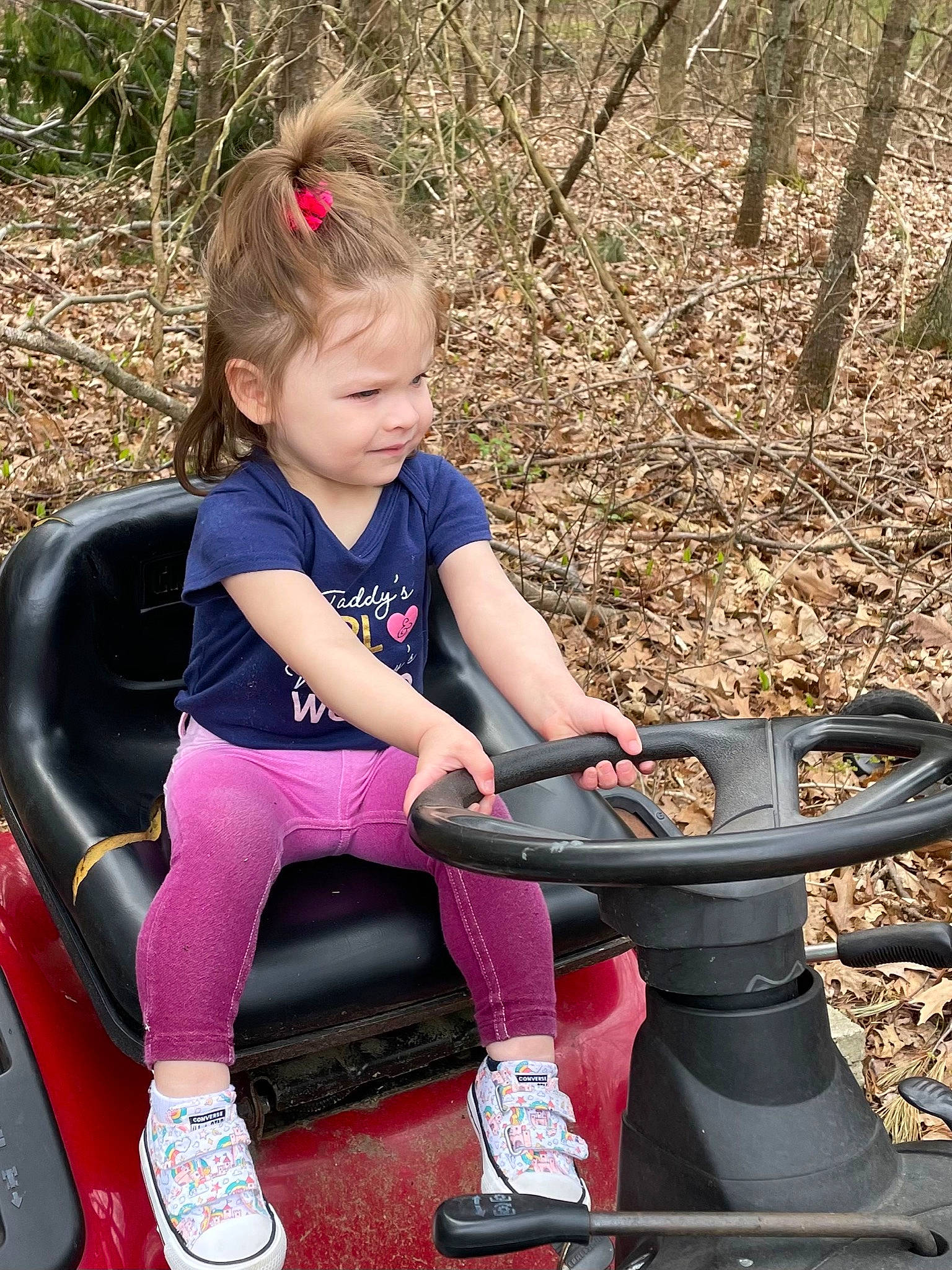 Zophia J is registered to the contest to win money with this photo: automotive_tire, eye, face, facial_expression, fun, grass, hairstyle, hand, happy, leg, leisure, people_in_nature, person, plant, recreation, shoe, smile, sneakers, toddler, tree