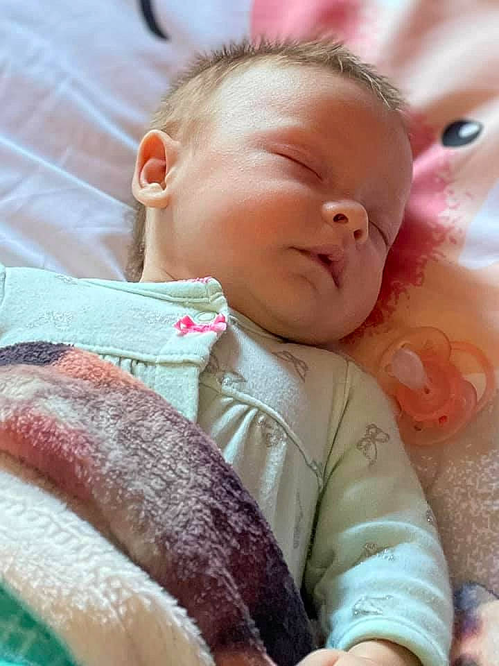 Zophia is registered to the contest to win money with this photo: baby, baby_products, baby_sleeping, baby_toddler_clothing, cheek, child, comfort, eyelash, finger, iris, linens, lip, mouth, nose, person, pink, product, skin, textile, toddler