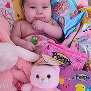 Ruby joined the competition — help win amazing prizes! baby, child, blanket, plush_toy, pink, candy, peeps, stuffed_animal, cute, indoor, portrait, smiling, toddler, soft_toys, colorful, face, hand, comfort, playful, cozy