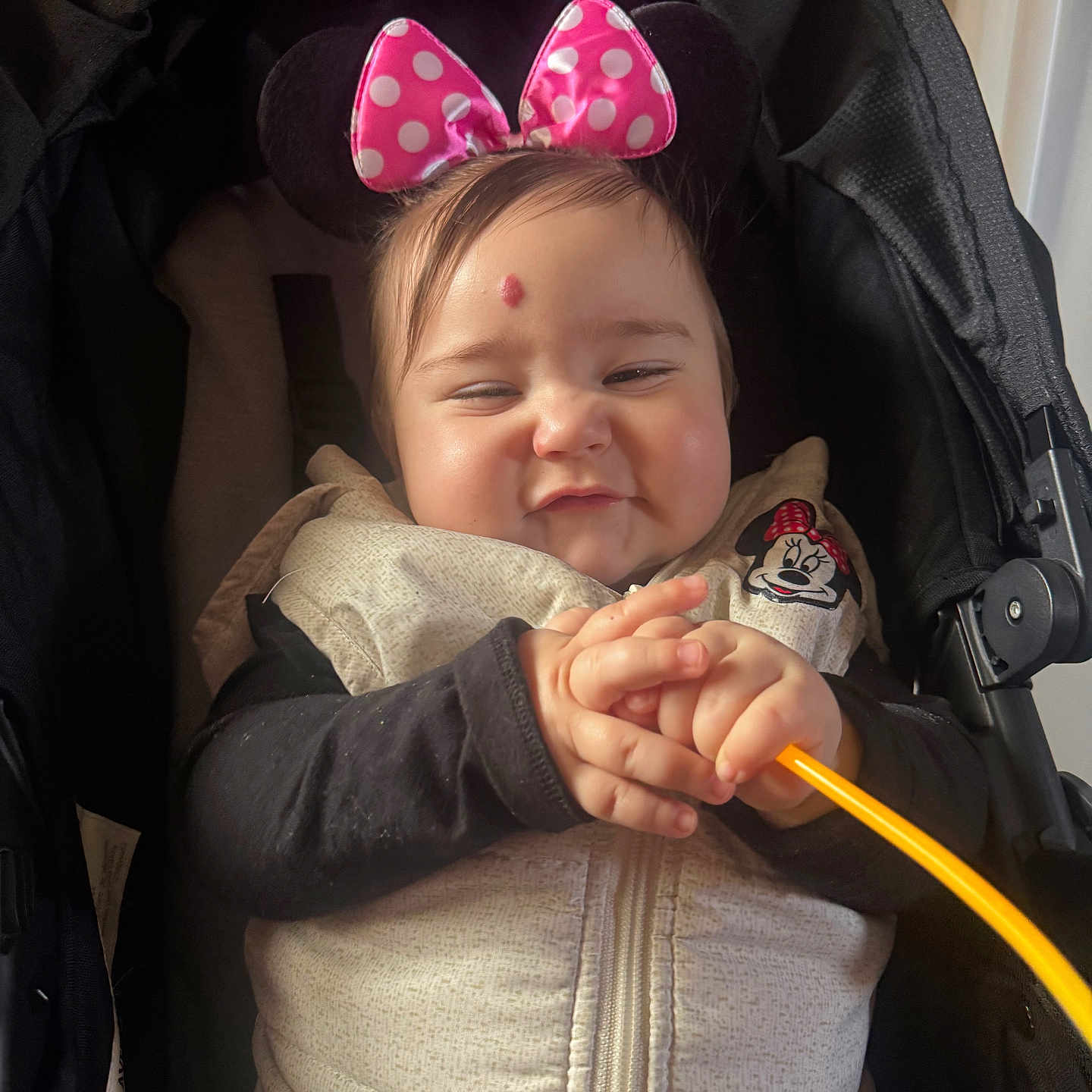 Elianna is registered to the contest to win money with this photo: baby, baby_girl, child, clothing, cozy, cute, face, hands, headband, indoor, infant, mickey_mouse, minnie_mouse, person, pink_bow, polka_dots, smile, stroller, toy, vest