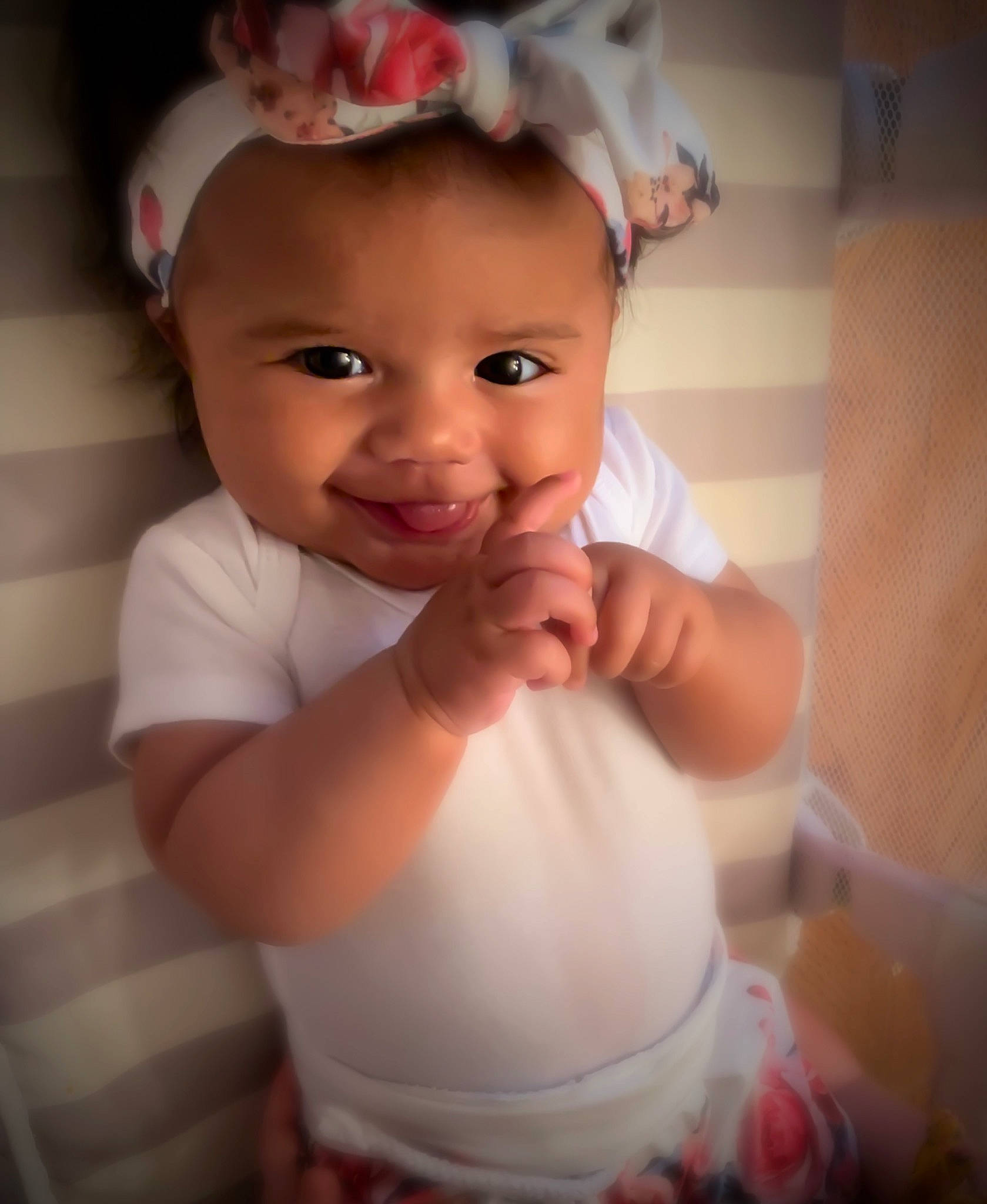 Ariya is registered to the contest to win money with this photo: baby, beauty, cheek, child, eye, face, facial_expression, finger, forehead, hair_accessory, hand, head, headgear, lip, mouth, nose, person, pink, skin, smile