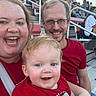 Noah joined the competition — help win amazing prizes! baby, bleachers, casual_clothing, child, crowd, daylight, event, family, glasses, happy, metal_railings, outdoor, parent, people, portrait, red_shirt, seating, smile, spectators, stadium
