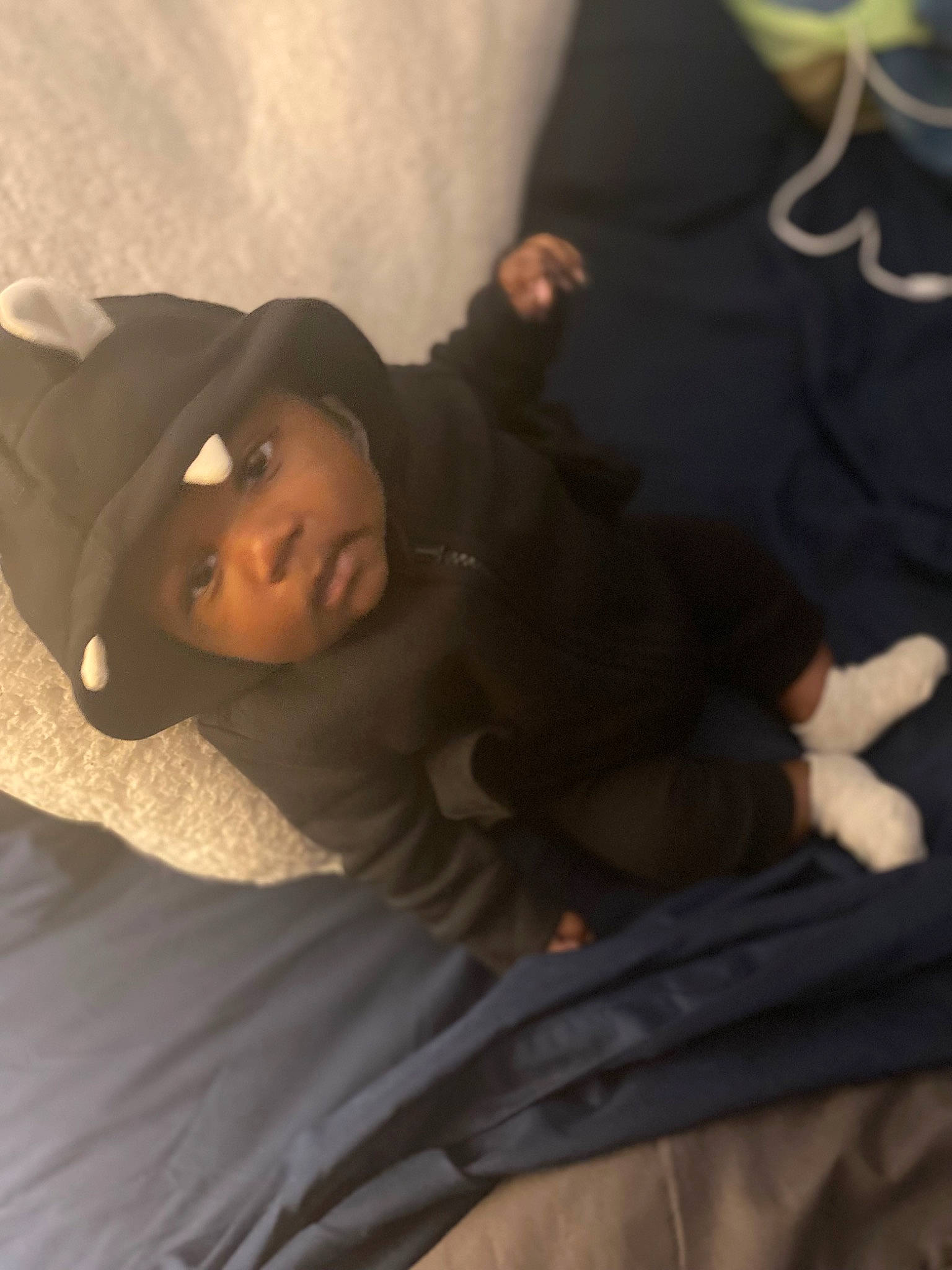 Cairo is registered to the contest to win money with this photo: baby, baby_sleeping, bed, bed_sheet, bedding, bedtime, child, cloud, comfort, elbow, fur, grey, happy, headwear, human_body, linens, outerwear, person, sleeve, t_shirt