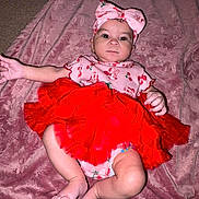Autumn is registered to the contest to win money with this photo: baby, infant, tutu, headband, pink_blanket, red_clothing, cute, child, lying_down, soft_texture, indoors, playful, small_feet, adorable, portrait, one_person, looking_at_camera, fabric, wrapped, resting