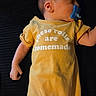 baby, sleeping, pacifier, yellow_onesie, text_on_clothing, infant, child, cute, peaceful, lying_down, closeup, skin, head, arm, hand, human, indoors, soft_lighting, rest, comfort